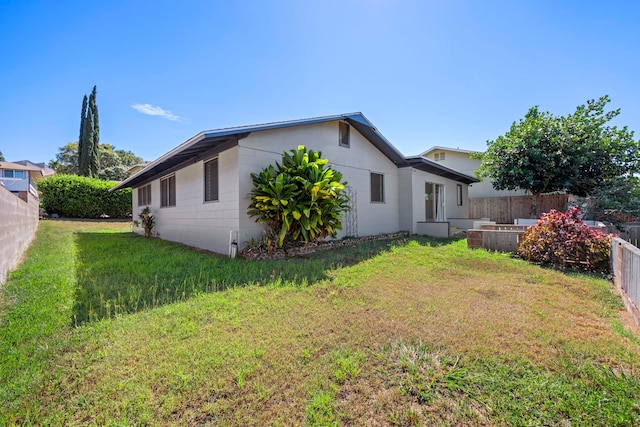 view of side of home featuring a yard