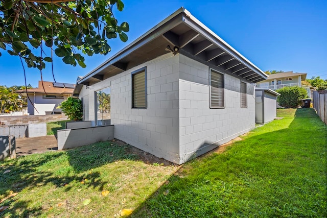 view of side of home with a yard