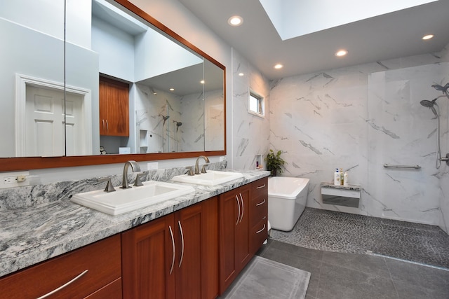 bathroom featuring vanity, independent shower and bath, tile walls, and tile patterned flooring