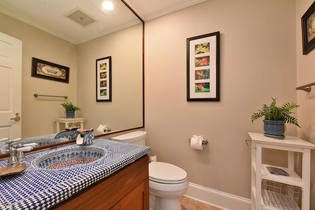 bathroom with vanity, crown molding, toilet, and tile patterned floors