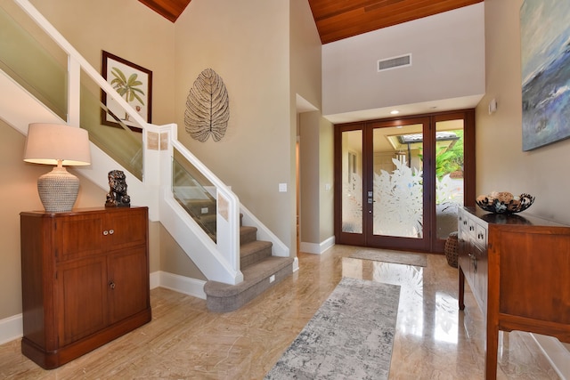 foyer featuring wood ceiling and high vaulted ceiling