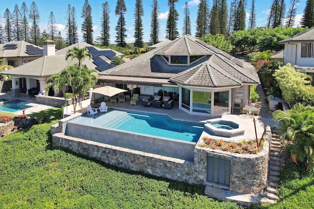 view of swimming pool with an in ground hot tub and a patio area