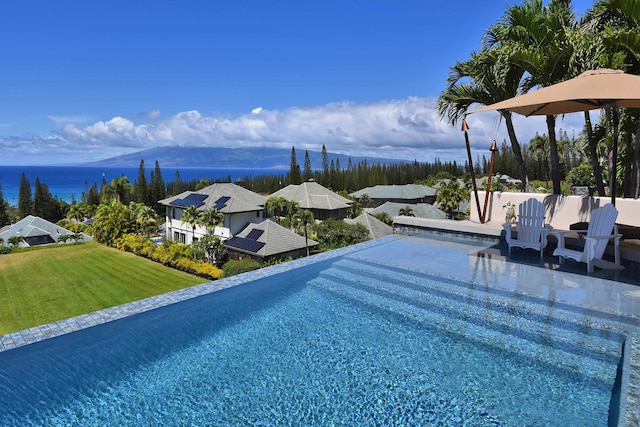 view of pool with a patio area and a lawn