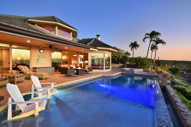 pool at dusk featuring an in ground hot tub, a patio area, ceiling fan, and outdoor lounge area