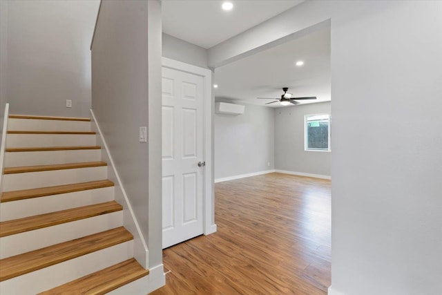 139 Mehani Pl, Kihei, HI 96753 - staircase featuring wood finished floors, a wall mounted air conditioner, ceiling fan, and recessed lighting
