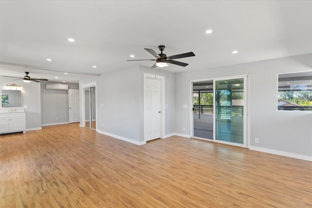 139 Mehani Pl, Kihei, HI 96753 - unfurnished living room with an AC wall unit, a ceiling fan, and a healthy amount of sunlight