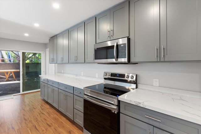 139 Mehani Pl, Kihei, HI 96753 - kitchen featuring light stone counters, recessed lighting, gray cabinetry, light wood-style floors, and stainless steel appliances