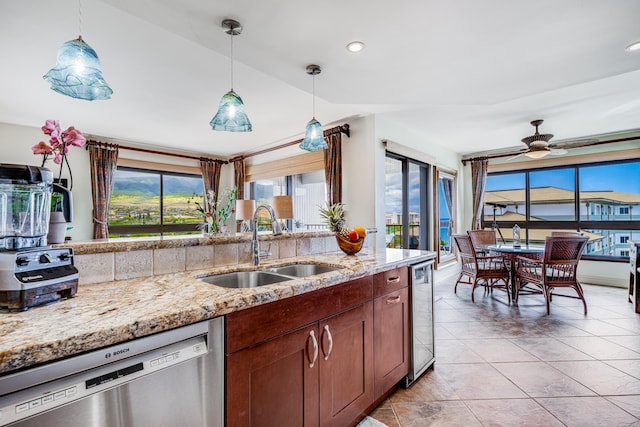 kitchen featuring dishwasher, decorative light fixtures, ceiling fan, and sink