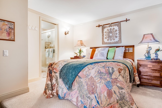 bedroom featuring carpet flooring, ensuite bath, and crown molding