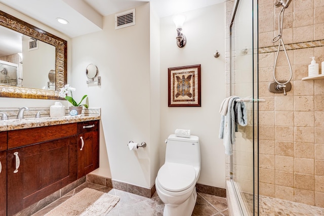 bathroom featuring tile patterned floors, a shower with door, vanity, and toilet