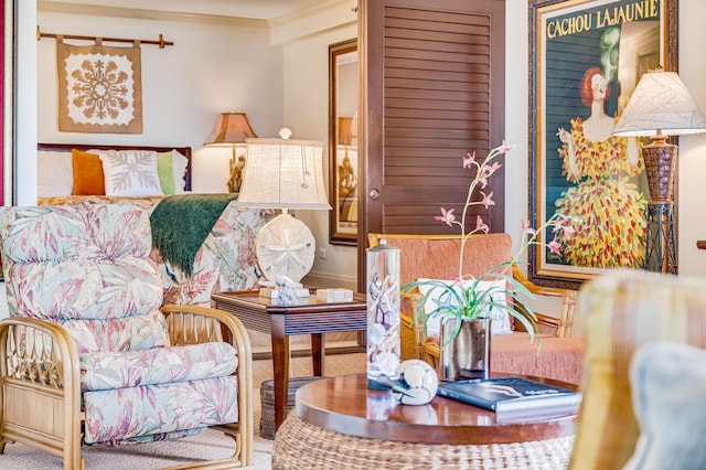 living area with carpet flooring and ornamental molding