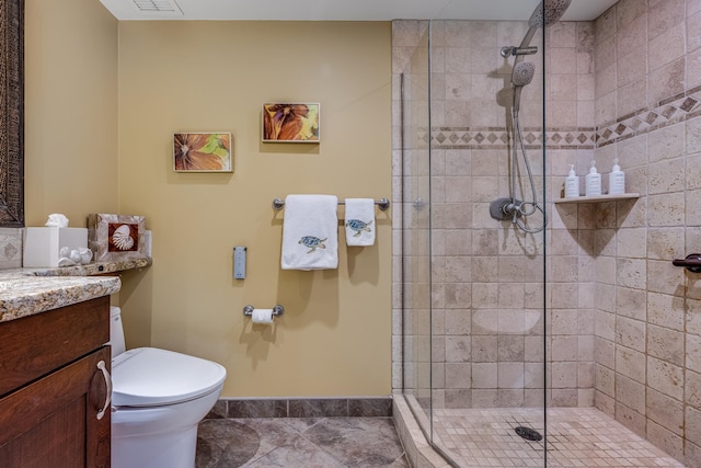 bathroom with tile patterned flooring, vanity, toilet, and walk in shower