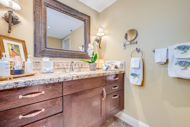 bathroom with vanity and tasteful backsplash