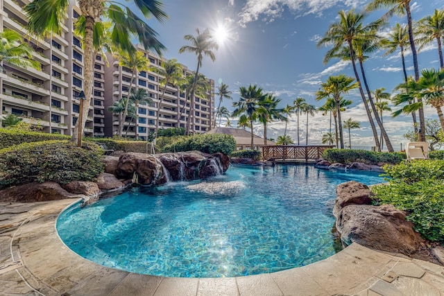 view of swimming pool with pool water feature