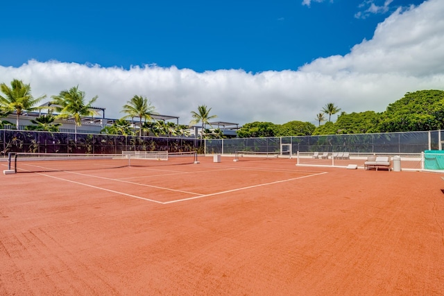 view of tennis court featuring basketball hoop