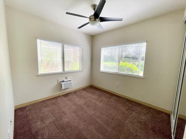 carpeted spare room with ceiling fan and a wall unit AC