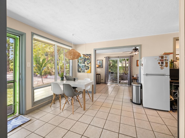 3100 Mapu Pl, Kihei, HI 96753 - dining area with light tile patterned flooring, a textured ceiling, and a ceiling fan