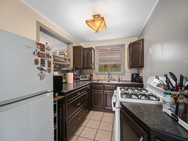 3100 Mapu Pl, Kihei, HI 96753 - kitchen with white appliances, dark brown cabinetry, backsplash, and light tile patterned floors