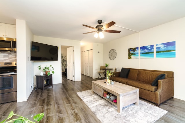 living room featuring dark hardwood / wood-style flooring and ceiling fan