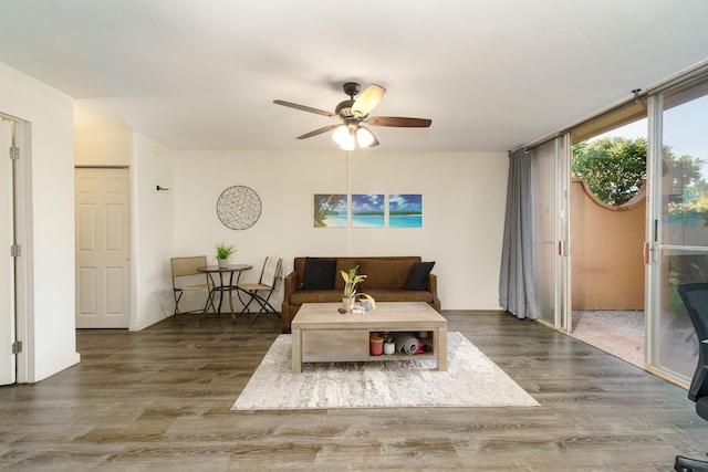 living room featuring dark hardwood / wood-style floors and ceiling fan