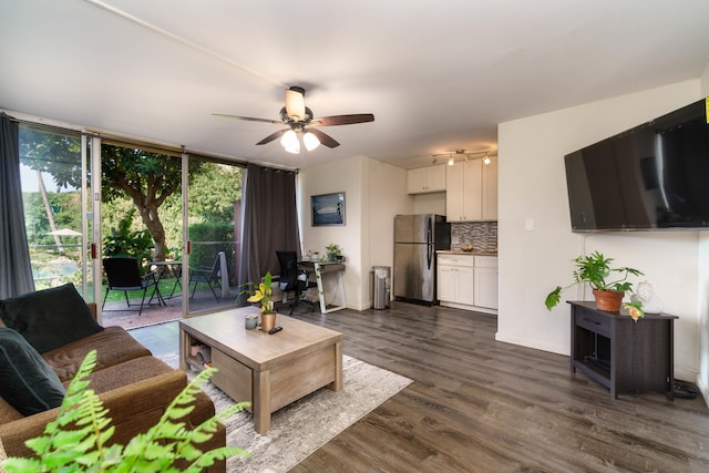 living room with ceiling fan and dark wood-type flooring