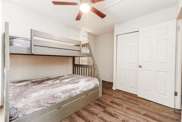 bedroom featuring ceiling fan, wood-type flooring, and a closet