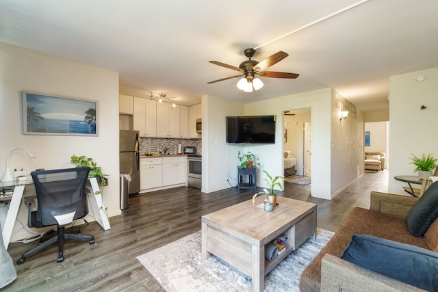 living room with dark hardwood / wood-style floors and ceiling fan