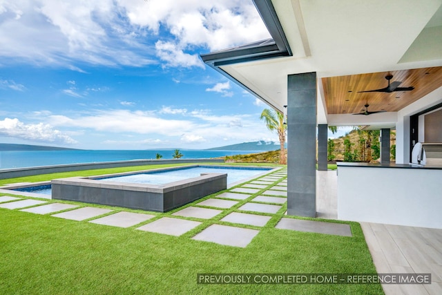91 Kumu Niu Pl Unit A, Lahaina, HI 96761 - view of pool featuring a water view, a ceiling fan, exterior bar, and a lawn