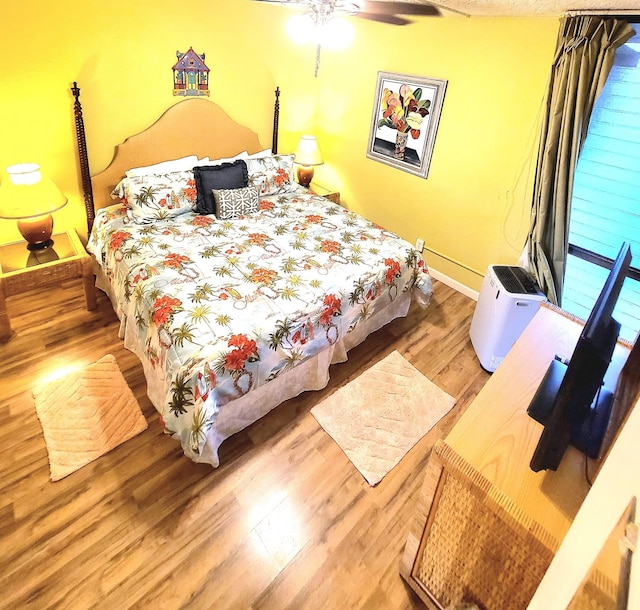 bedroom with ceiling fan and hardwood / wood-style floors