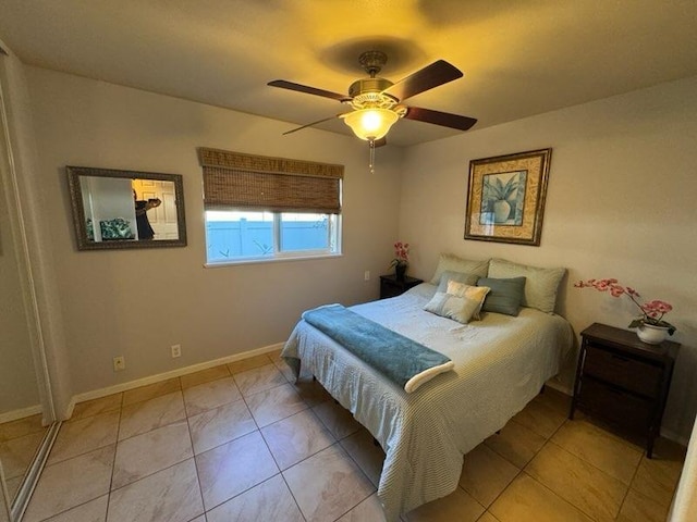 tiled bedroom featuring ceiling fan