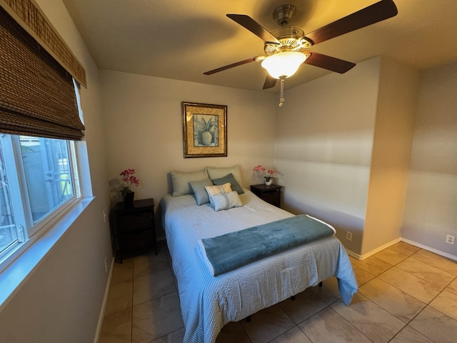 bedroom with ceiling fan and light tile patterned floors