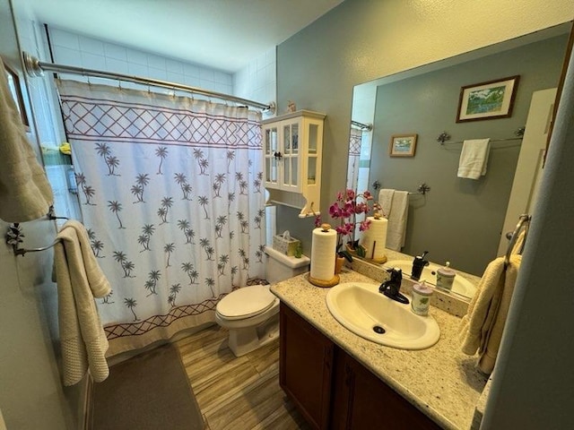 bathroom with vanity, toilet, and walk in shower