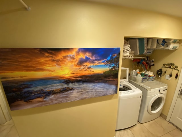 laundry room with washer and dryer and light tile patterned floors