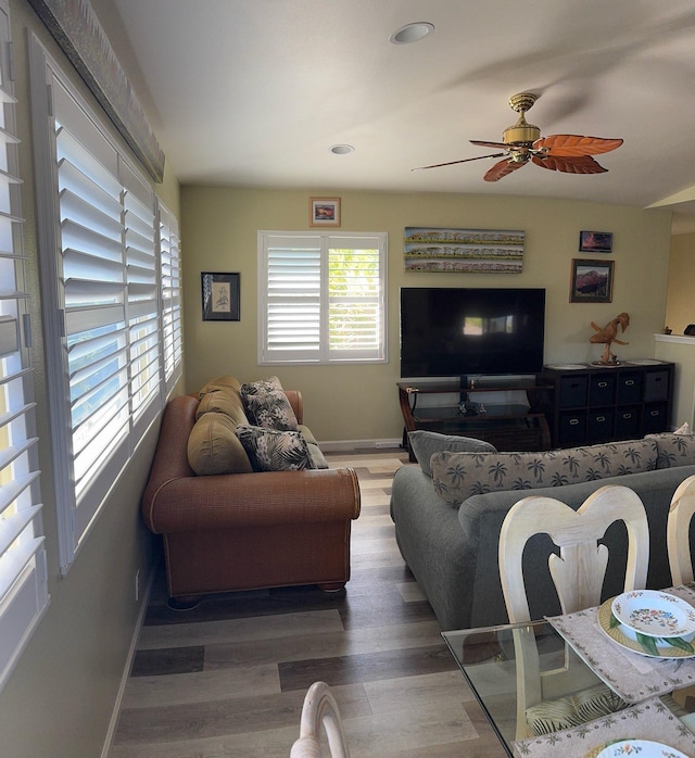 living room featuring ceiling fan, plenty of natural light, and hardwood / wood-style flooring