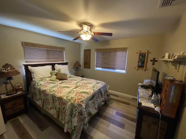 bedroom with hardwood / wood-style floors and ceiling fan