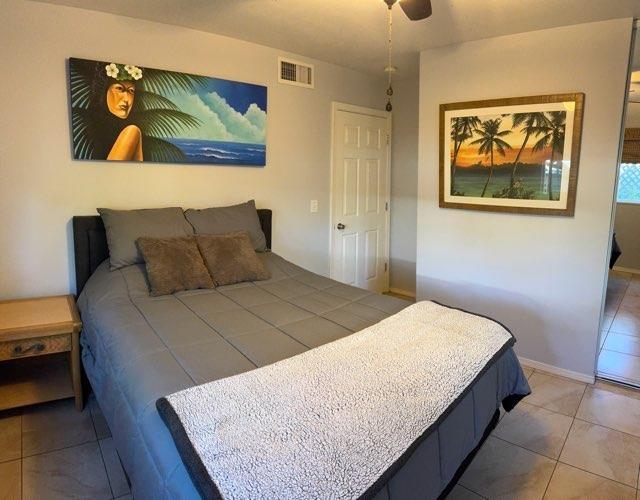 bedroom featuring tile patterned flooring and ceiling fan