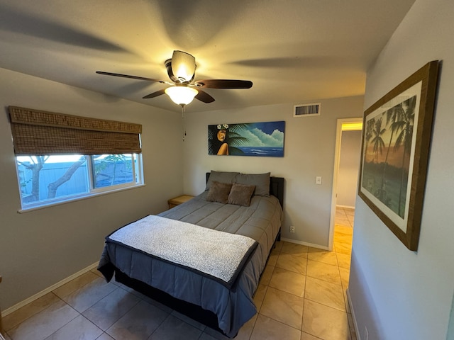 tiled bedroom featuring ceiling fan