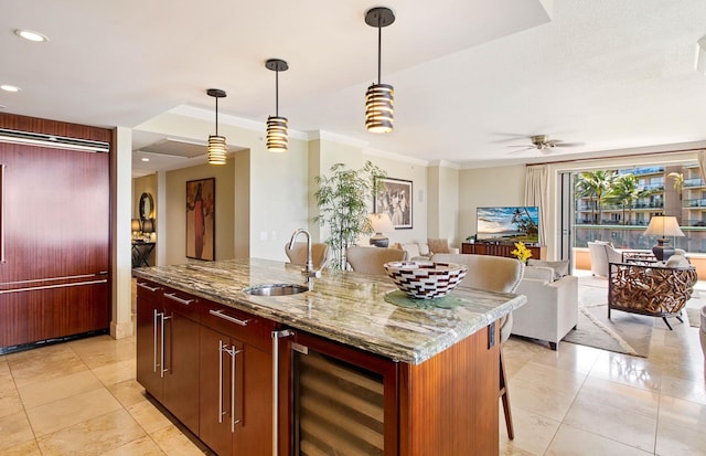130 Kai Malina Pkwy Unit Nr202, Lahaina, HI 96761 - kitchen featuring beverage cooler, a sink, open floor plan, an island with sink, and crown molding