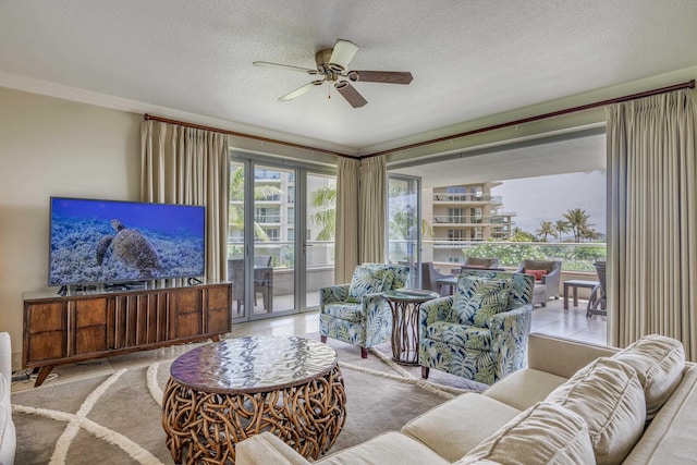 130 Kai Malina Pkwy Unit Nr202, Lahaina, HI 96761 - living area with a ceiling fan, a textured ceiling, and ornamental molding