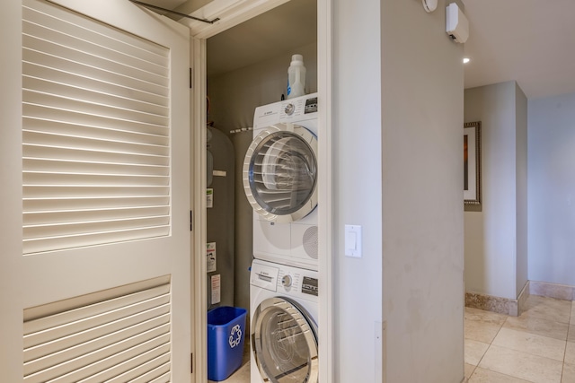 130 Kai Malina Pkwy Unit Nr202, Lahaina, HI 96761 - washroom featuring estacked washer and dryer, baseboards, and light tile patterned flooring