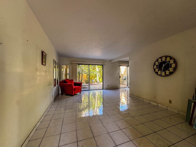 90 Auhana Rd Unit 202, Kihei, HI 96753 - living room featuring light tile patterned flooring and baseboards