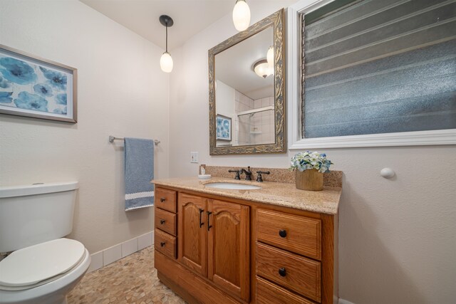 bathroom with tile floors, toilet, and vanity