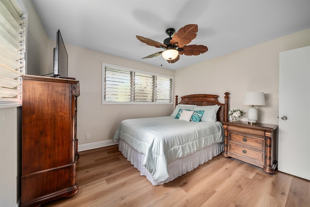 bedroom with ceiling fan and hardwood / wood-style flooring