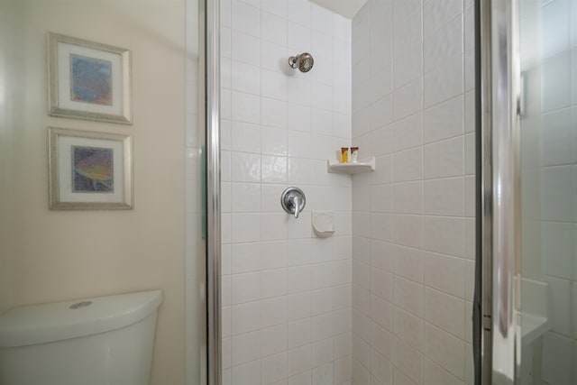 bathroom featuring an enclosed shower and toilet