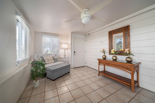 sitting room featuring ceiling fan and light tile floors