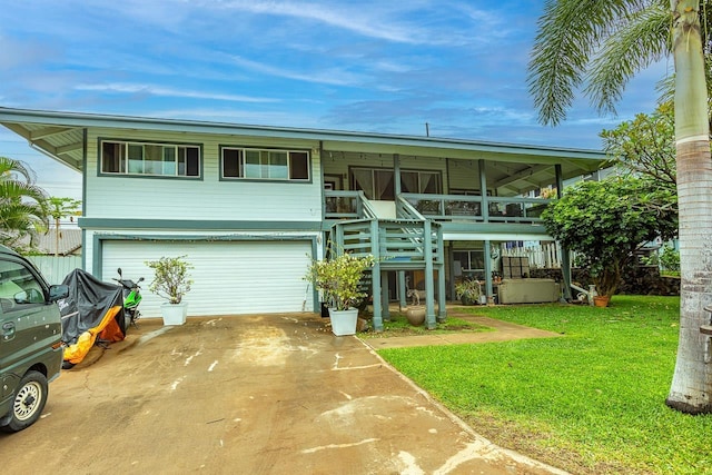 view of front facade with a garage, a sunroom, and a front lawn