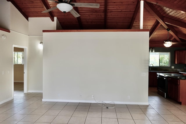 interior space with beamed ceiling, light tile patterned flooring, sink, and ceiling fan