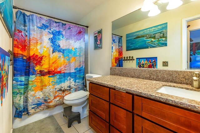 bathroom featuring vanity, tile patterned floors, and toilet