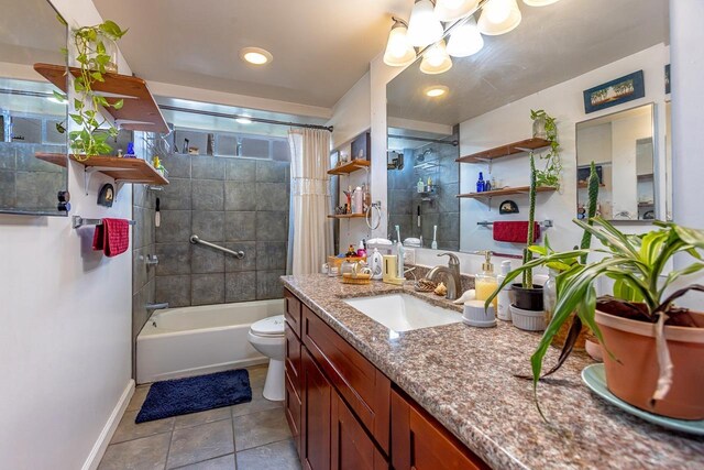 full bathroom with vanity, tiled shower / bath, tile patterned floors, and toilet