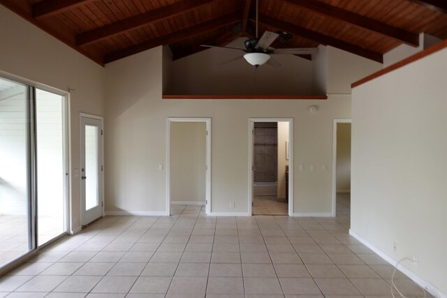 kitchen featuring light tile patterned floors, stainless steel range with electric cooktop, black fridge, and sink